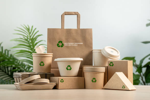 istock Eco Friendly Packaging for a Sustainable Future. Paper tableware  from natural recyclable with a recycling sign .Responsible consumption, zero waste concept. 2162630372