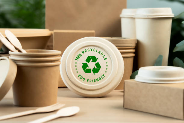 Eco Friendly Packaging for a Sustainable Future. Paper tableware  from natural recyclable with a recycling sign .Responsible consumption, zero waste concept.