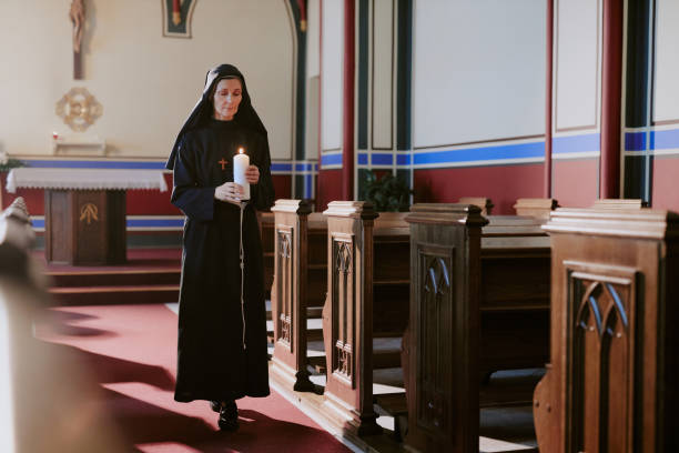 istock Catholic Nun Carrying Burning Candle 2162630458