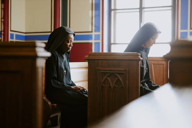 istock Two Christian Nuns Praying In Church 2162631473