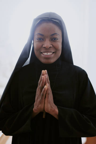 istock Cheerful Black Nun With Praying Hands 2162631543