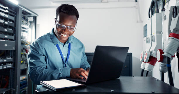 istock Man, laptop and engineer coding in server room, firmwear update and programmer for cyber security. Developer, confident and IT support or upgrade network with tablet, database and data centre or tech 2162632092