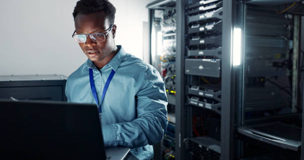 istock Man, laptop and engineer working in server room, firmwear update and programmer for cyber security. Developer, confident and IT support or upgrade network for gdpr, database and data centre with tech 2162632095