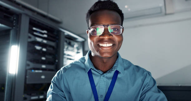 istock Man, happy and smiling or working in server room, system update and firmware installation or program developer. Online, network and cybersecurity or IT engineer, datacenter and professional employee 2162632104