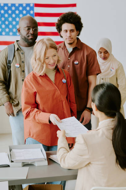 istock Diverse Men And Women Taking Ballot Papers 2162634393