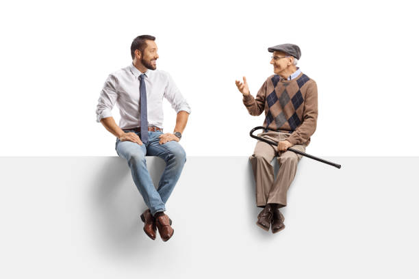 istock Businessman and an elderly man sitting on a panel and discussing 2162638340