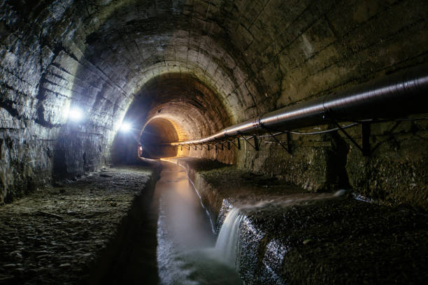 istock Underground vaulted urban sewer tunnel with dirty sewage 2162640717