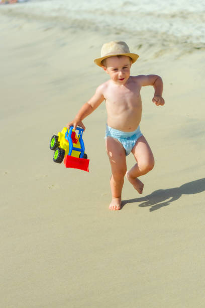Boy playing at the beach stock photo