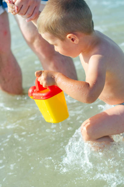 Boy playing at the beach stock photo