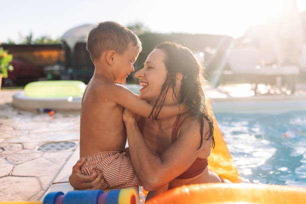 istock Mother and child bonding poolside on a sunny day 2162643591