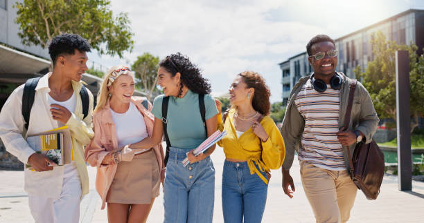 istock Happy, university and conversation with friends and class diversity on college campus with smile. School, education and students with joke and backpack outdoor at learning academy with people 2162644438