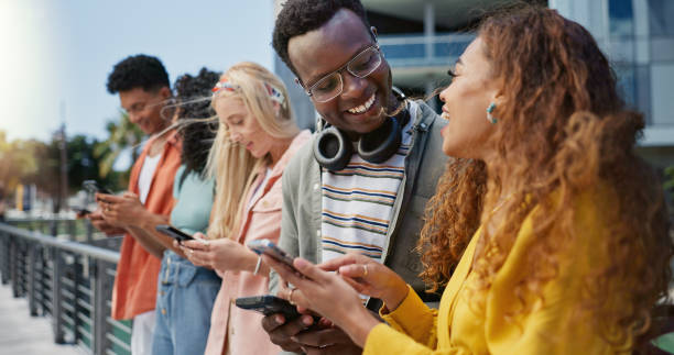 istock Friends, students and happy with phone at college, campus or laughing for diversity, learning or development. Gen z group, women and men on mobile app, web chat and meme on social media in university 2162644452