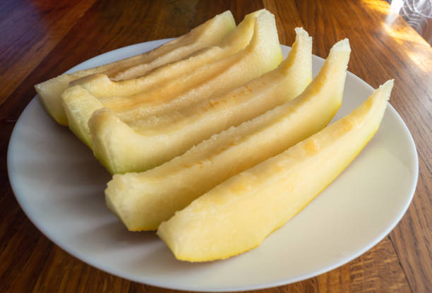 Sliced ​​melon on a plate close-up. Melon slices on a plate