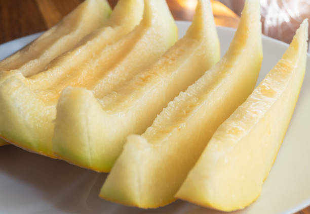 Sliced ​​melon on a plate close-up. Melon slices on a plate