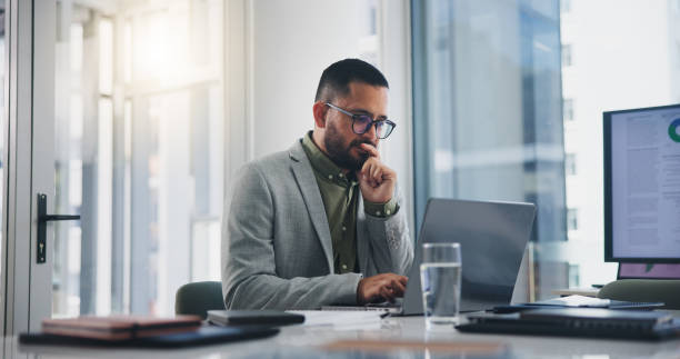 Man, thinking and laptop with ideas, solution and decision for business, workplace and office. Male person, working and account management for planning, vision and goal in brainstorming for project