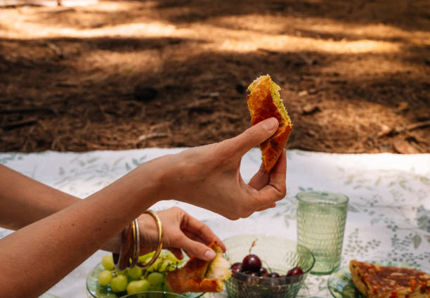 Woman eating a sandwich in a picnic