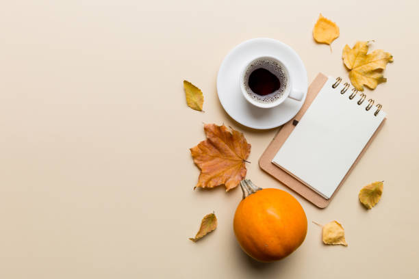 istock Autumn composition: fallen leaves and notebook mock up on colored background. Top view. Flat lay with copy space 2162649015