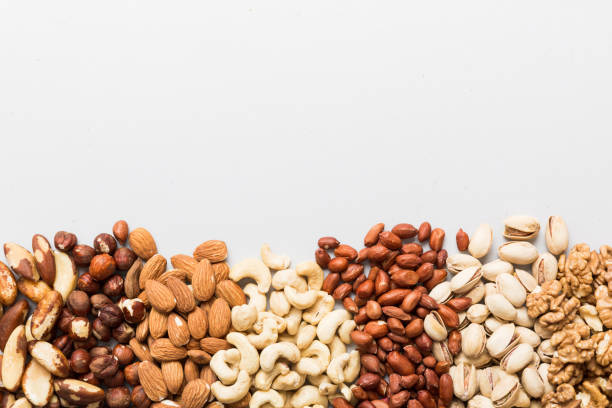 istock different nuts frame background. Close up, top view, flat lay with vopy space. Walnut, pistachios, almonds, hazelnuts and cashews 2162649075