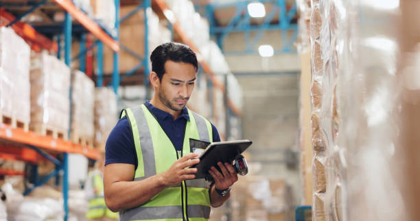 Man, boxes and scanner with tablet in logistics, e commerce or inventory of order or courier solution. Serious industrial worker with digital software for price check, information or package schedule
