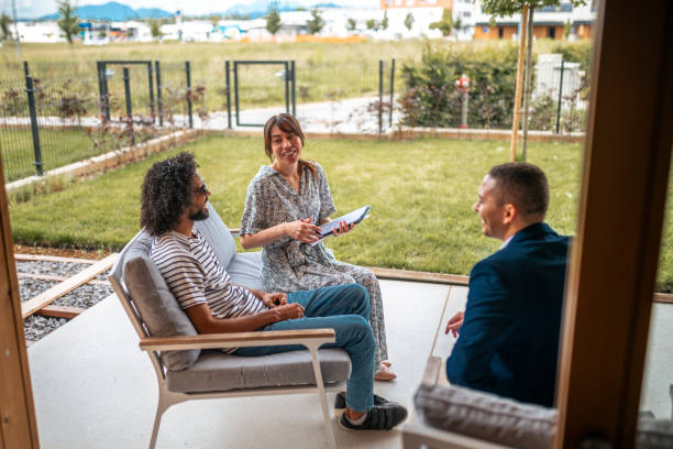 Diverse Couple Engaged in Home Purchase with Real Estate Agent