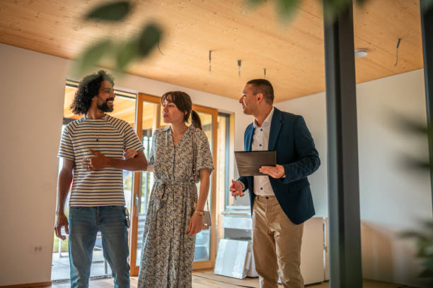 istock Hispanic Real Estate Agent with Clients in Home Viewing 2162651103