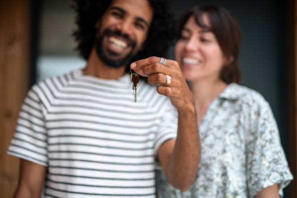 istock Joyful Diverse Couple Holding New Home Key 2162651112