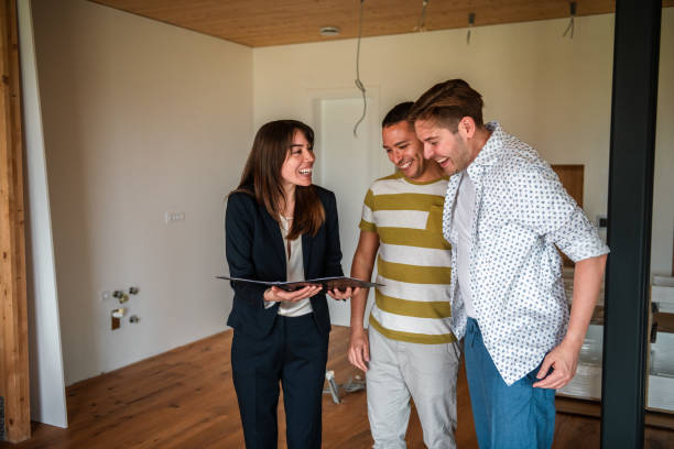 istock Gay Couple Finalizes Home Purchase with Hispanic Agent 2162651118