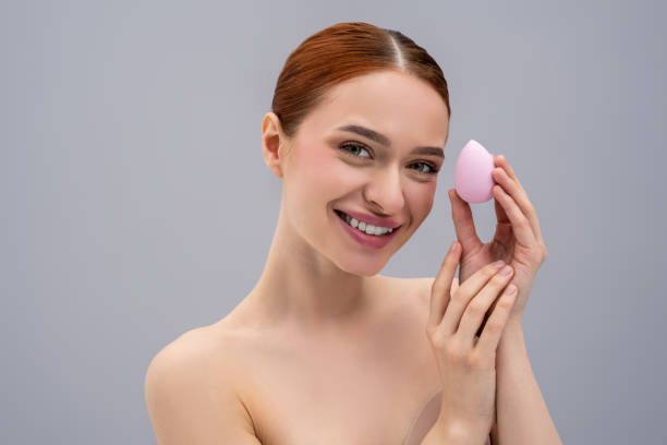 istock Pretty ginger caucasian woman using absorbing face sponge and smiling 2162652226