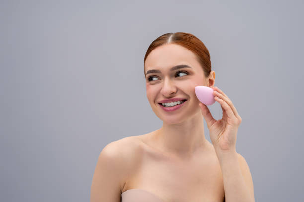 istock Pretty ginger caucasian woman using absorbing face sponge and smiling 2162652228