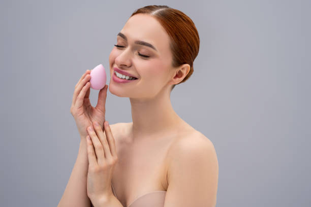 istock Pretty ginger caucasian woman using absorbing face sponge and smiling 2162652232