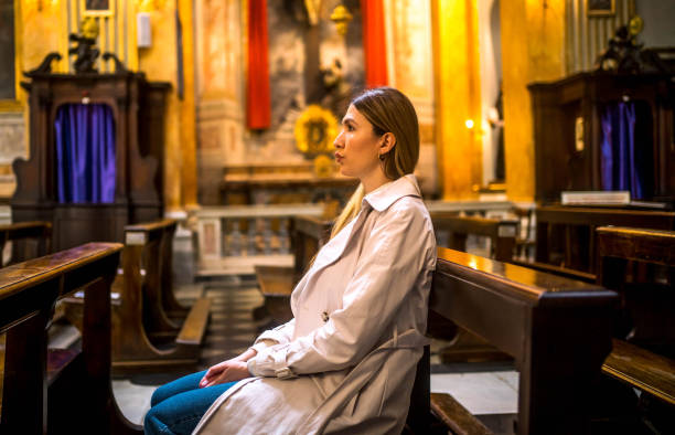 istock Woman in a Catholic church 2162655209