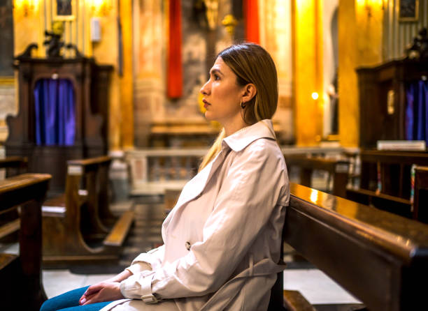 istock Woman in a Catholic church 2162655354