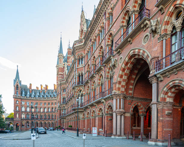 Part of the exterior of London St Pancras International station, with the integral 5* St Pancras Renaissance Hotel at the far left of the photo. Designed by William Henry Barlow and opened in 1868, St Pancras is one of the most important London train termini, and is the terminus for Eurostar trains to Europe. Grade I Listed Building.