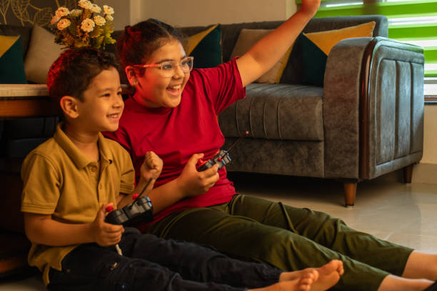 istock Cheerful siblings playing video game at home 2162656904