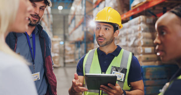 istock Man, tablet and group in warehouse for logistics with discussion, planning or check inventory. Women, people and team with digital touchscreen on app for supply chain, inspection and cargo in factory 2162659902