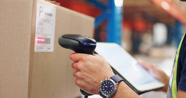 istock Logistics, hands and man scanning barcode in warehouse with tablet for price or serial number. Cardboard, package and closeup of male cargo worker with digital technology for inventory in storage. 2162659910