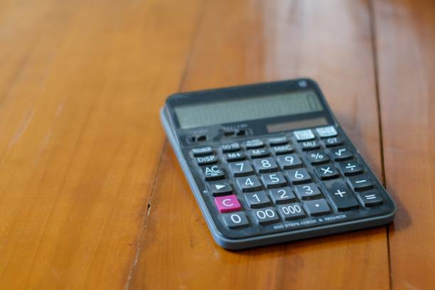 istock A black Calculator on a wooden floor background. Top view 2162662744
