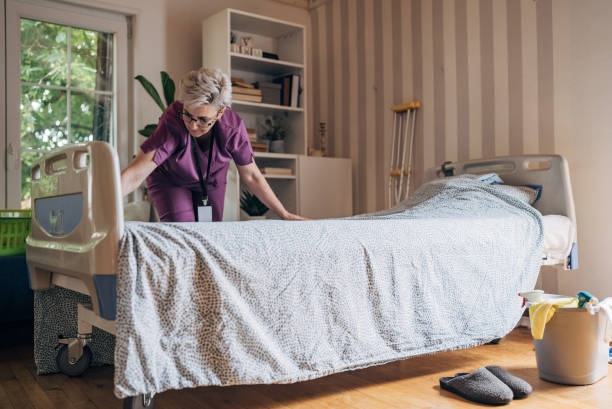 istock Healthcare worker making a bed in a patient's room 2162663743