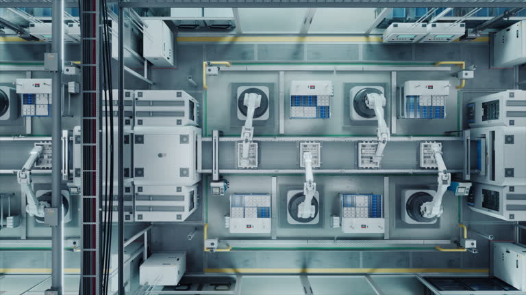 Top Down View with Autonomous Factory with Robotic Arms Assembling Components on a Production Line, Showcasing Advanced Automation and Engineering in a Industrial Environment. Fast Forward Footage