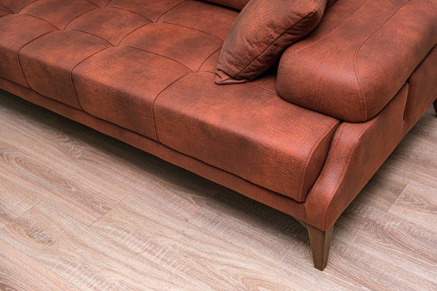 istock A brown couch with a brown leather cover and brown pillows. 2162664943