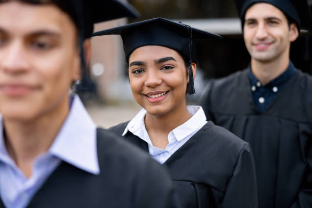istock Happy student standing out from the crowd on her graduation day 2162665208