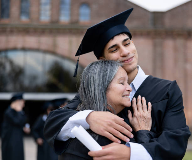 istock Proud mother hugging her son while celebrating his graduation 2162665212