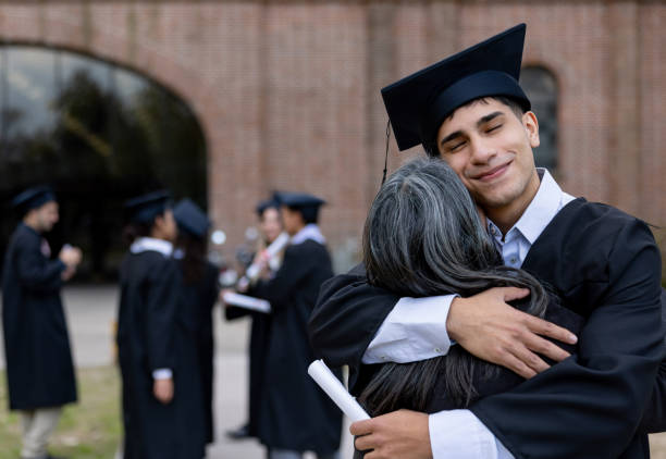istock Graduate student hugging his mother on his graduation day 2162665218