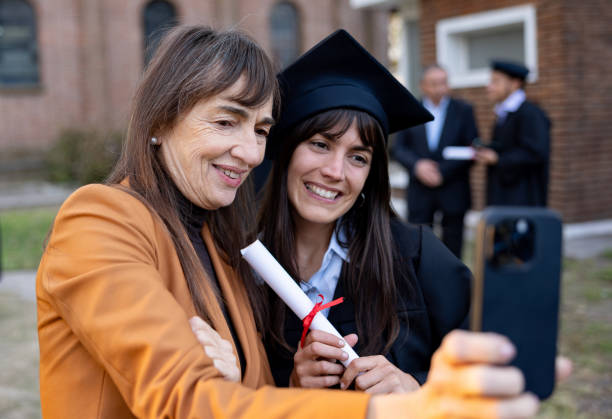 istock Graduate student taking a selfie with her mother on her graduation day 2162665221