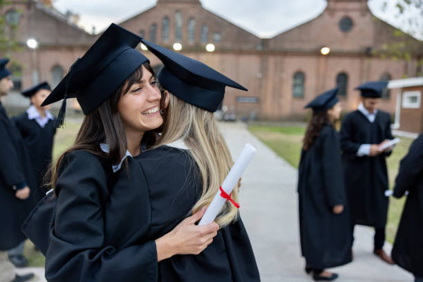 istock Happy friends hugging on their graduation day 2162665260