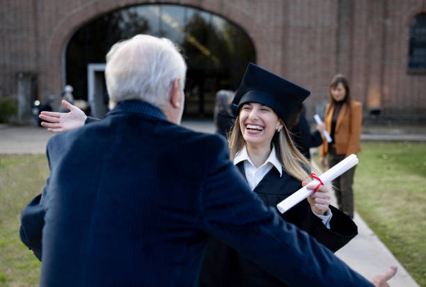 istock Happy graduate student running to hug her father after getting her diploma 2162665292