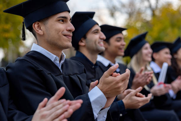 istock Students applauding the commencement speech at their graduation ceremony 2162665298