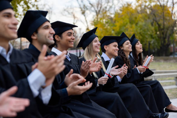 istock Happy group of students applauding in their graduation ceremony 2162665313