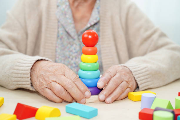 istock Asian elderly woman playing game. 2162666181