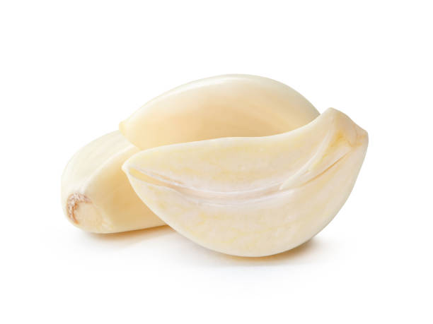 istock Front view of peeled white garlic cloves with half in stack isolated on white background with clipping path 2162670334